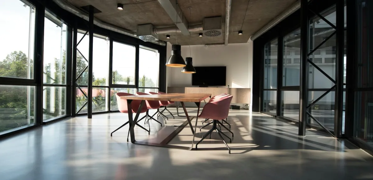 Sala de reunión con mesa de madera y luz natural